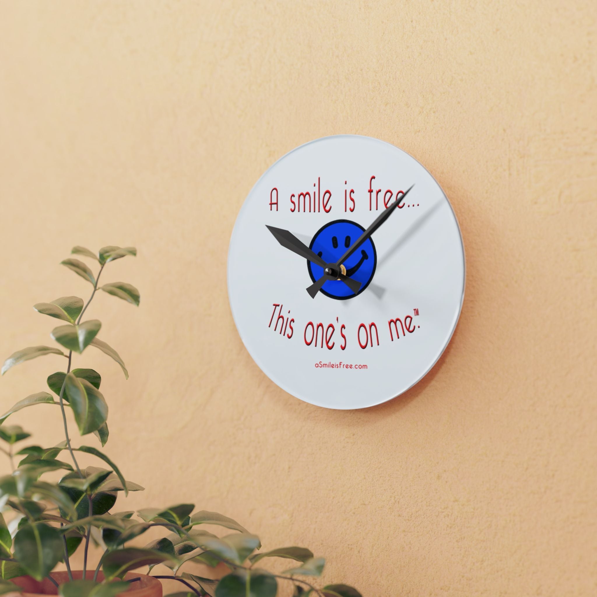 Round acrylic wall clock hanging on wooden wall
